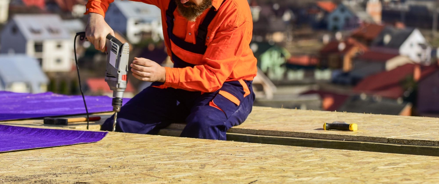 Image of a worker fixing a roof.